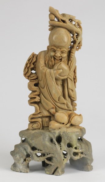 Chinese carved soapstone, Shou Lao, 15"h: Chinese carved soapstone sculpture of Shou Lao, the God of Longevity, raised on a carved stone base, 14.5"h x 7.5"w x 4"d.