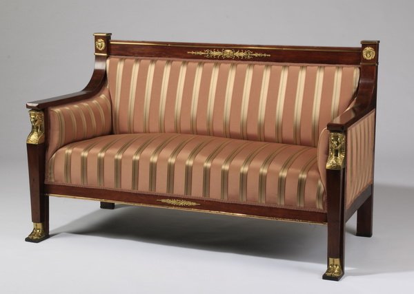 French Empire style canape, in apricot silk: Late 19th or early 20th century French Empire style canape, of mahogany with gilt anthemion and lion heads along the straight back and apron, the front legs in the form of term figures, upholstered in