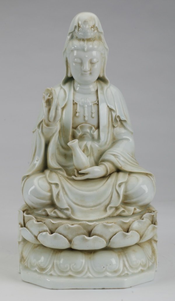 Chinese porcelain blanc-de-chine Guanyin, 13": Chinese porcelain blanc-de-chine Guanyin with flowing robes, seated in a meditative pose on a double lotus throne, 13.25"h x 8"w x 7"d.