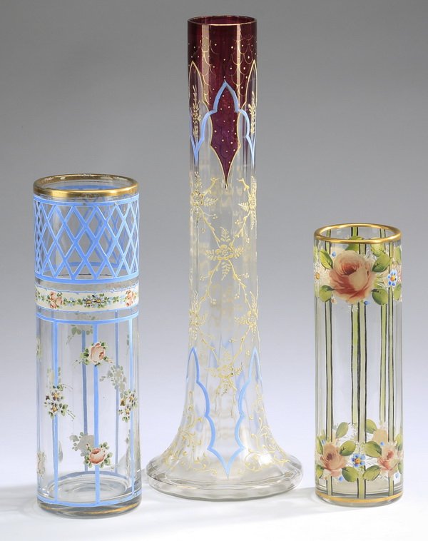 (3) Enamel decorated glass vases: Group of three enamel decorated glass vases, each executed in clear glass with hand painted floral decoration in red, blue, and green, (1) 10"h x 3"dia; (1) 12"h x 3.75"dia; (1) 17.5"h x 6"dia.