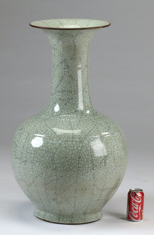 Oversized Chinese porcelain vase, 32"h: Oversized Chinese porcelain bottle neck vase, having a light blue ground with crackle glaze, the flared rim outlined in brown, the whole resting on a circular foot, 32"h x 18" diameter.