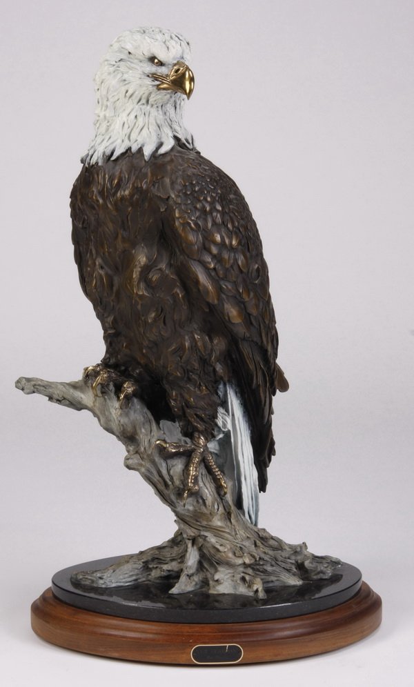 32"h bronze eagle sculpture by E. Thorsen: Contemporary polychrome decorated bronze sculpture of an American bald eagle, on revolving walnut base with black granite insert, by noted American Western sculptor Eric Thorsen, 32"h x 18"w at the ba