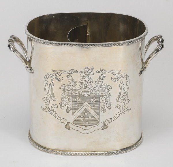 English style silver plate wine cooler: English style silverplate two-handled wine cooler, 20th century, etched with crest depicting a shield surmounted by a standing lion, 7"h x 9"l x 4.25"w.
