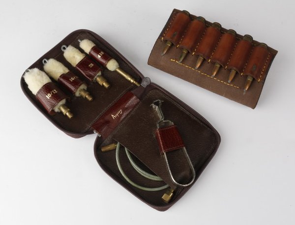 Asprey rifle cleaning kit: Asprey rifle cleaning kit, with tools for cleaning 10/12, 16/20, 28 and 410 and other tools in a leather zip up case 1"h x 5" square closed, open .75"h x 5"w x 9.5"d.