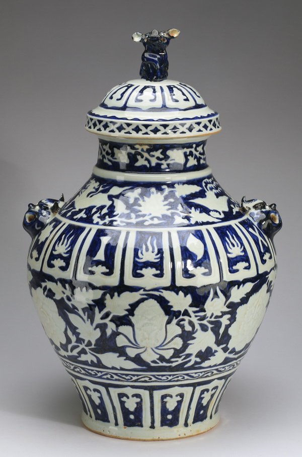 Chinese 'Eight Buddhist' symbols jar, 19"h: Chinese blue and white covered jar, having a Fu lion finial and lappet band on the lid, surmounting the body decorated with multiple bands of papercut resist, including lotus scroll, mythical beasts, 