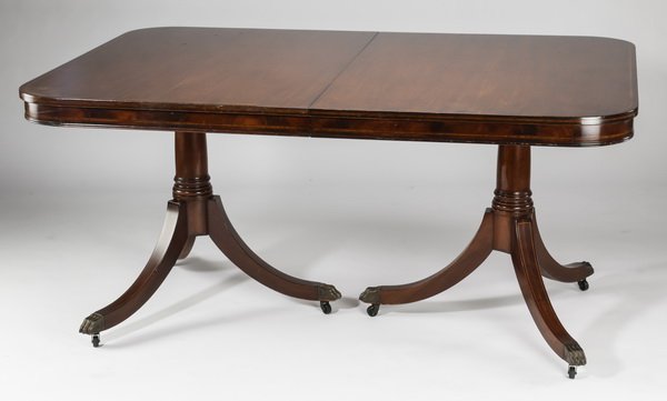 Duncan Phyfe style mahogany dinning table, 62"l: Duncan Phyfe style mahogany dinning table, 20th century, the rectangular top with rounded corners having cross band inlay, above an apron with string inlay, rising on two Doric pedestals each with tri