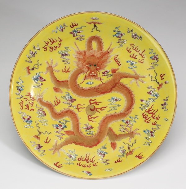 Chinese famille rose dragon bowl, Qianlong mark, 9"w: Chinese famille rose shallow dragon bowl, centering a writhing five clawed dragon and a flaming pearl of wisdom amidst auspicious cloud forms and flames, all on a yellow ground, the exterior having sc