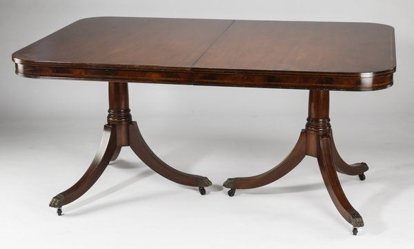 Duncan Phyfe style mahogany dinning table, 62"l: Duncan Phyfe style mahogany dinning table, 20th century, the rectangular top with rounded corners having cross band inlay, above an apron with string inlay, rising on two Doric pedestals each with tri