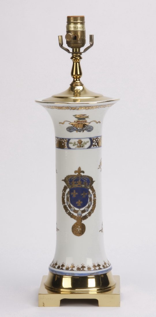 Hand painted vase converted to a table lamp: Hand painted ceramic vase converted to a table lamp, the white ground with central royal blue shield featuring fleur-de-lis and gilt details, 20"h x 6" square base.