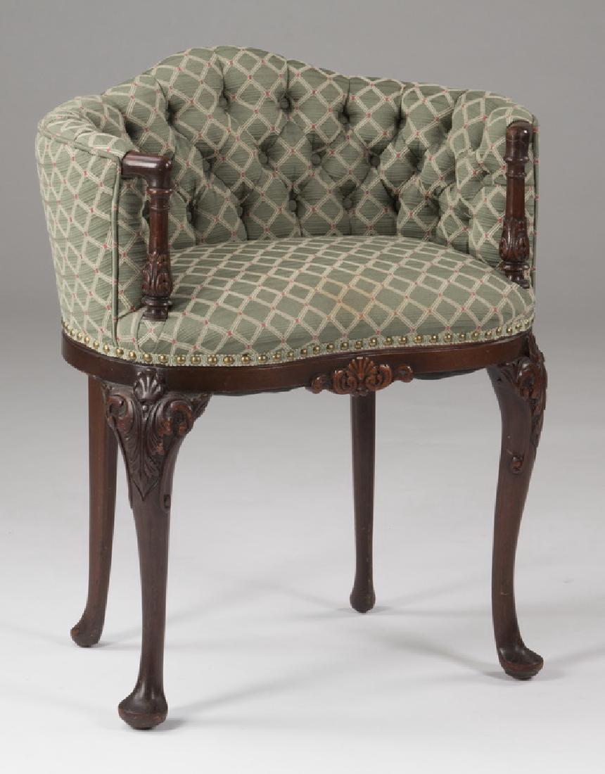 Mahogany venity chair with tufted upholstery: Rococo style mahogany vanity chair covered in a tufted diamond pattern upholstery in shades of green and accented with brass nail head trim, the slightly arched, continuous curved arms ending with sho