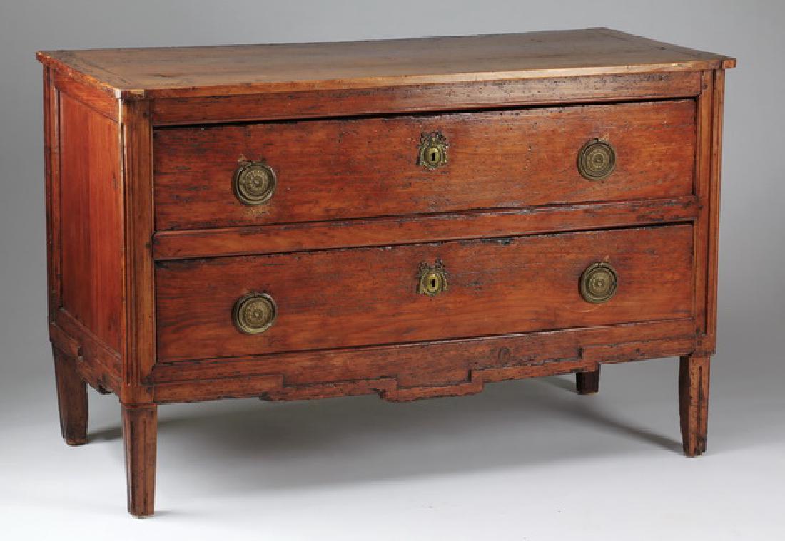 French chestnut commode, late 18th c.: French commode, late 18th or early 19th century, executed in chestnut with carved detail, the top surmounting two drawers mounted with brass ring pulls centering rosettes and keyhole escutcheon plates