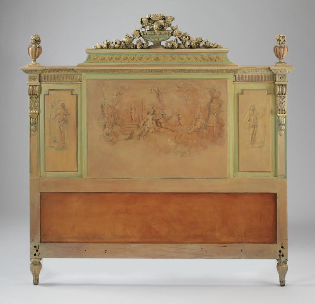 French paint decorated headboard, 57"w: French Neoclassical style paint decorated headboard, late 19th or early 20th century, with pierced and carved crest centering an urn with flowers flanked by reeded urns, above a relief carved entablat