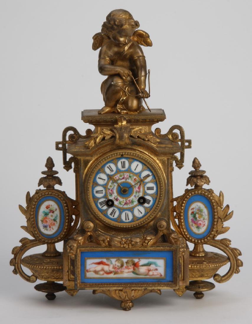 19th c. bronze and Sevres style porcelain clock: Late 19th century Louis XV style dore' bronze figural clock, the Sevres style turquoise blue porcelain clock face surmounted by a seated Cupid with bow and arrow, flanked by inset hand painted floral