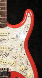 Bloc Party / The Zutons: a guitar autographed by bands: Bloc Party / The Zutons: a guitar autographed by both bands, a Stratocaster guitar, with a Fiesta Red finish, signed on the scratchplate by Kele Okereke, Russell Lissack, Gordon Moakes, Matt Tong,