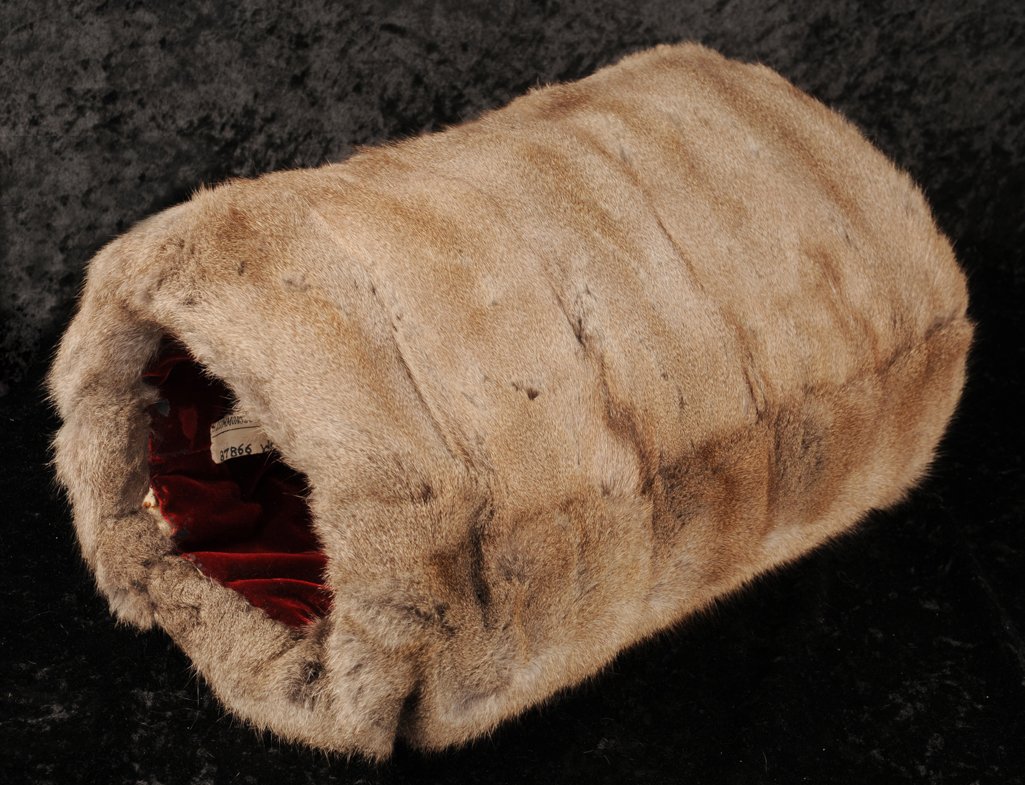 Film: Elizabeth Taylor large chinchilla fur muff: Film: Elizabeth Taylor from 'Hotel' episode 'Intimate Strangers', 1984, large chinchilla fur muff the grey chinchilla muff bearing label 'J. Simmons & Co Covent Garden'