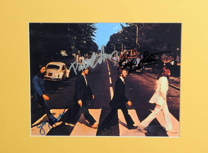 The Beatles: An autographed publicity photograph: The Beatles: An autographed publicity photograph, the colour photograph taken in Abbey Road signed by John Lennon, Paul McCartney, George Harrison and Ringo Starr in blue ballpoint pen by Lennon,