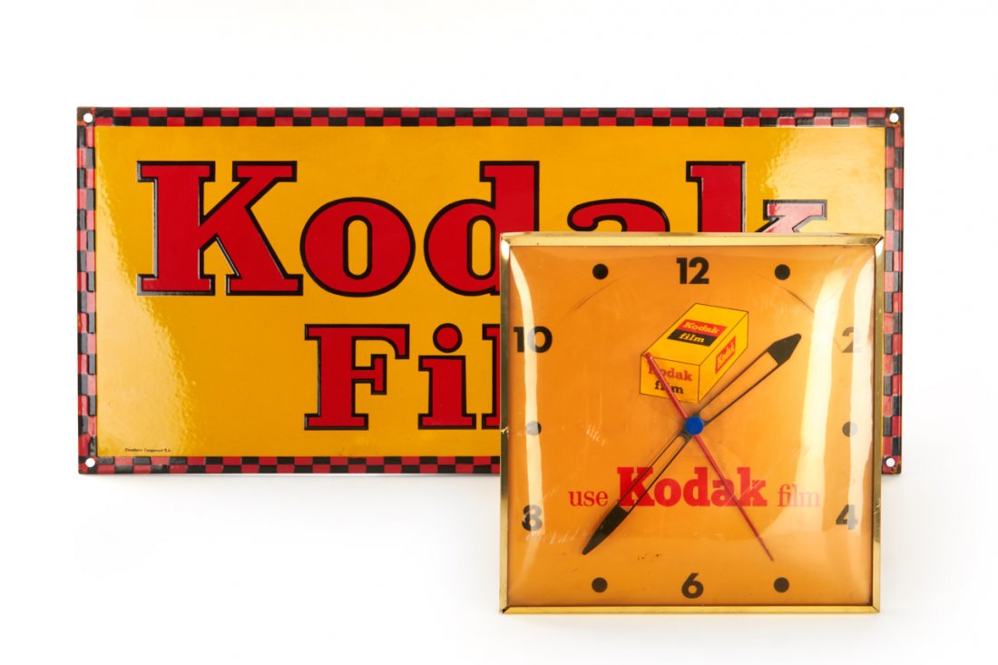 Kodak Advertising Material, c.1950: large Kodak Film enamel sign c.92x41cm in very good condition, together with Kodak wall clock 'Use Kodak Film', c.39x39cm The buyers premium for all items exported out of E.C. (European Community) is
