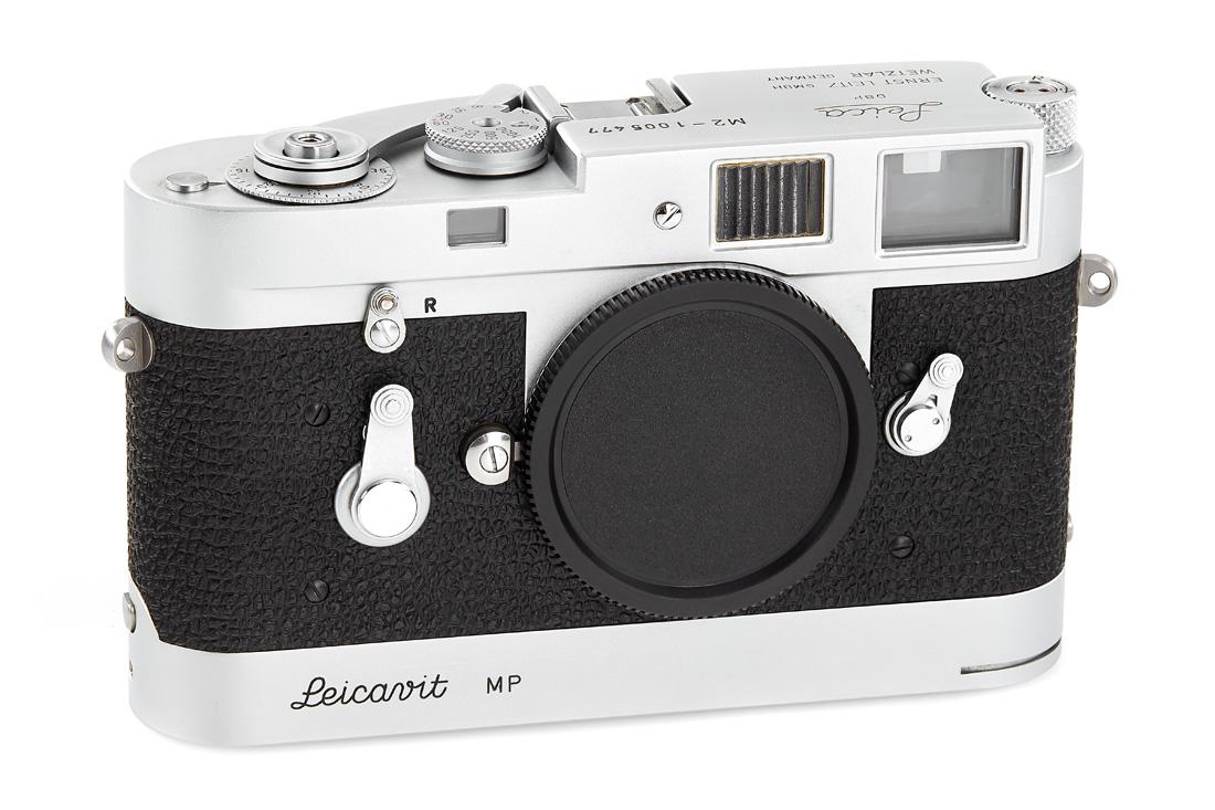 Leica M2 chrome + Leicavit MP *: body in near mint condition (top plate replaced by Leica in 1970's) and in very good working order, with chrome Leicavit MP (cond. B/A), body cap The buyers premium for all items exported out of E.C.