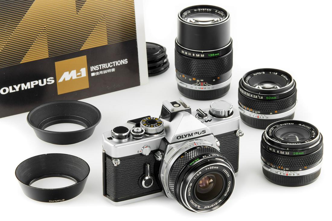 Olympus M-1 outfit: Introduced in 1972, the M-1 was meant to be a part of a 'M-System', it did not last long, though, before Leica protested against the name of the system and Olympus decided to change the name to OM sys