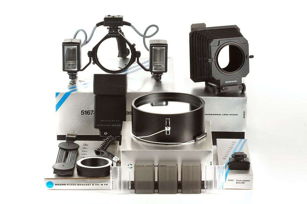 Hasselblad Accessories (various): (1) Macro flash unit 51678 with instructions in maker's box, (2) Macro Flash Bracket 50-70 51657 in maker's box, (3) Flash adapter SCA 390 51681 in maker's box, (4) Linear Mirror Unit TIBAC in maker's