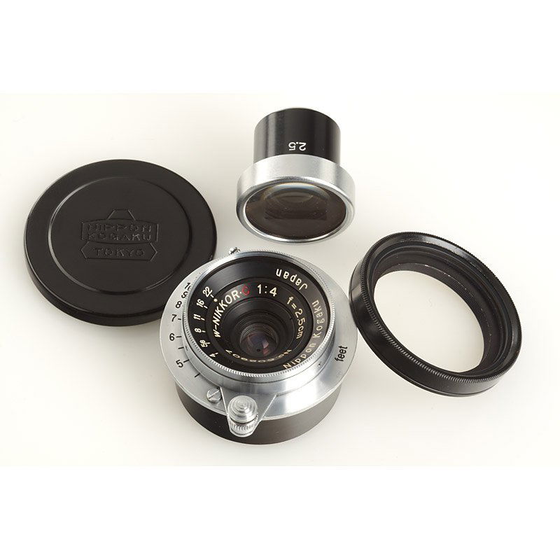 W-Nikkor-C 4/2.5cm , SN: 502907, c.1954: rare RF coupled Nikkor for M39, original Nikon M39 screw mount lens cap, Tokyo front cap, very rare original hood with UV filter, 2.5cm finder, both in perfect condition with Nikon keeper - ex Tad Sat