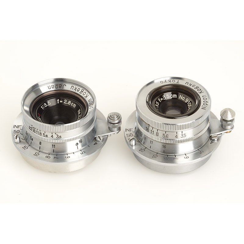 Nikon W-Nikkor-C (various): two wide-angle Nikkor lenses in RF coupled M39 screw mount: (1) W-Nikkor-C 3.5/2.8cm no.347654, E-P engraved (cond. B/A, rear cap), (2) quite rare and early Tokyo W-Nikkor-C 3.5/3.5cm no.910582, on re
