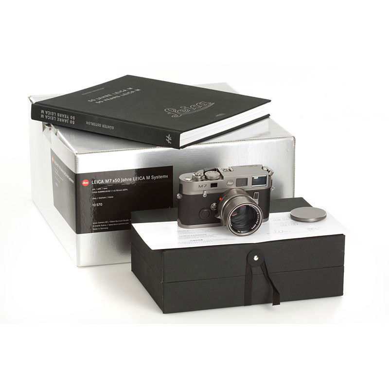 M7 Titan "50 Jahre Leica M System" 10570, no. 3000: limited edition M7 in titanium finish, a few minimal signs of use on the leather covering and strap lugs, complete with matching Summilux-M 1.4/50mm Asph. No.3982501 and all accessories with maker's b