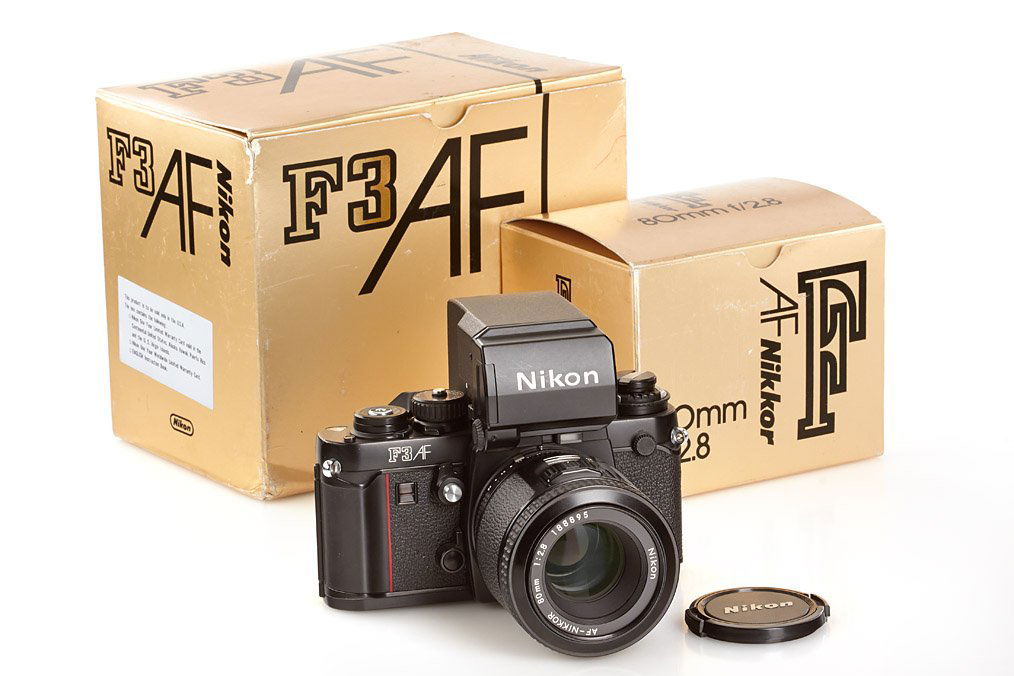 Nikon F3AF outfit, ser.no.8305440, 1983: body in mint condition with AF-Nikkor 2.8/80mm no.188895, caps, instructions, maker's boxes