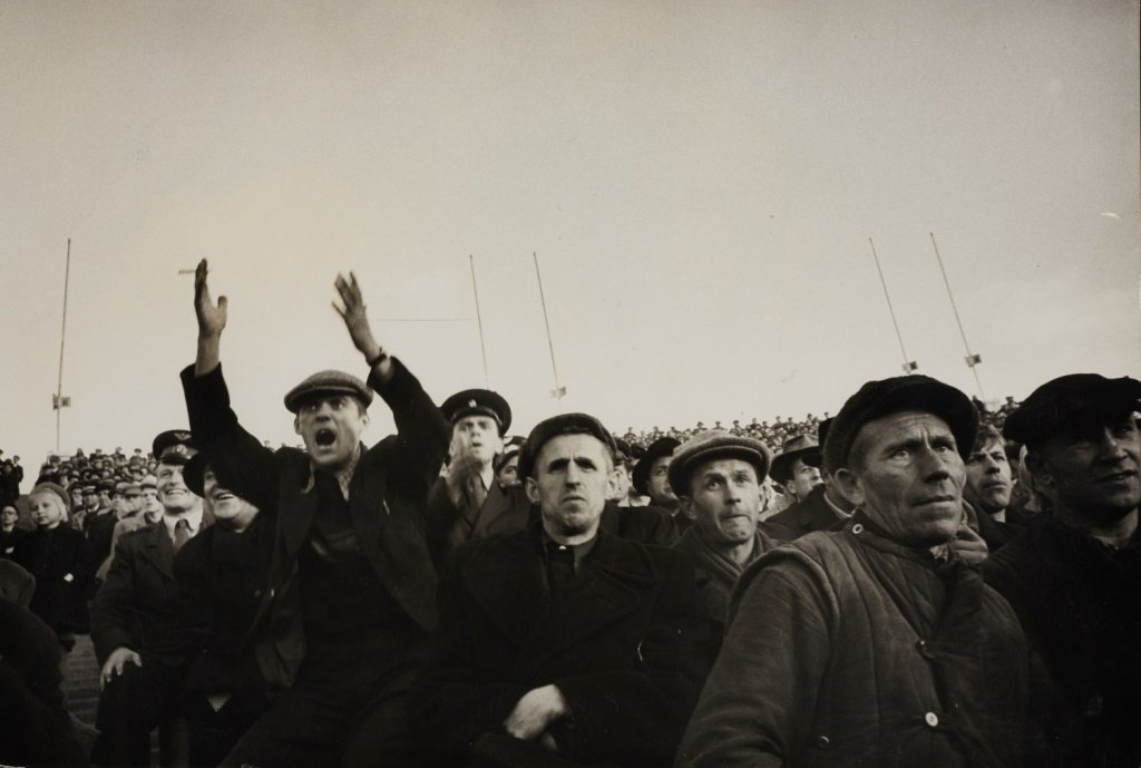 CORNELL CAPA (1918–2008) Spectators at the Kirov stadiu: Vintage silver print 16,9 x 24,8 cm (6.7 x 9.8 in) Photographer's credit stamp and “a.b.c. press” stamp on the reverse