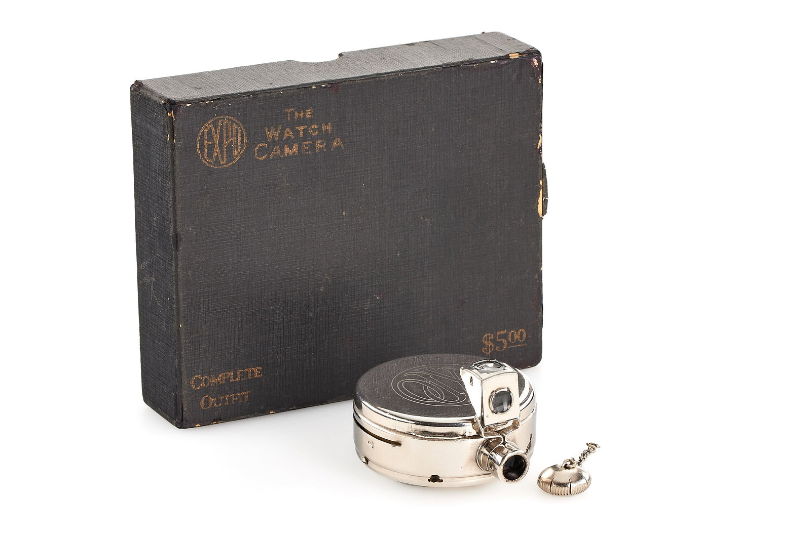 Expo Watch Camera: Sought-after classic detective camera stylized like a pocket watch, chromed body in very good condition, outfit with angle finder, with original cap (still with its chain), and rare maker's box, the