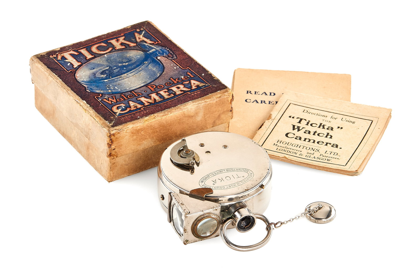 Houghton Ticka Pocket Watch Camera: Classic sought-after pocket watch-style spy camera, nickel plated version in very good condition, with cap, angle finder, film cartridge, instructions and original maker's box.