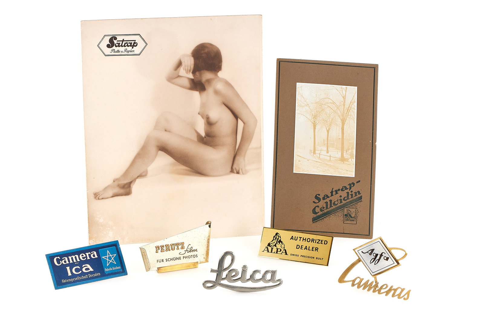 Advertising Material Various: Set of 7 various advertising material including a poster for film and paper brand Satrap, nude portrait 27x34cm on card board, small stain spots in a corner, counter display for Satrap colloidin paper