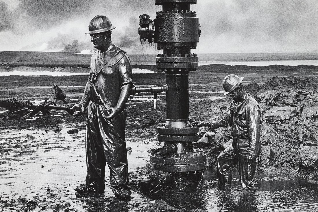 SEBASTIÃO SALGADO (1944–2025) - Workers, Greater Burhan Oil Field, Desert on Fire, Kuwait 1991: Vintage silver print 24,2 x 36,1 cm (9.5 x 14.2 in) Signed and annotated (with technical details) by the photographer in pencil on the reverseThe print comes with the original issue of the New York Ti