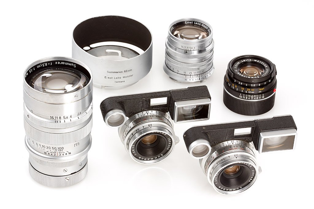 Leitz M Lenses (Lot): (1) M3 Summaron 2.8/35mm no.1904350 (cap), (2) M3 Summaron 2.8/35mm no.2101494 (caps, maker's box), (3) Summicron-C 2/40mm no.2705821 (hood, caps, maker's box), (4) Summarit 1.5/5cm no.1434318, Summar