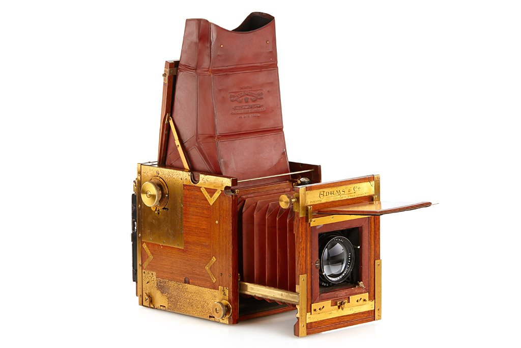 Adams Minex Tropical: 4x5", rare tropical version, teakwood body with brass fittings, brown leather bellows, finder hood marked 'DE LUXE MODEL', with Tessar 4.5/210mm no.16922, focal plane shutter (needs service), black do