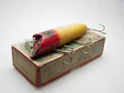 Heddon Basser #8502 Lure: Red / White BX-2 up leaping box, age lines and some chipping. Grade: Average