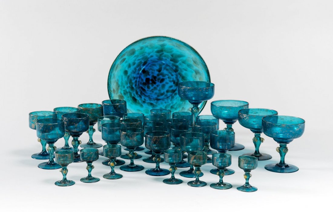 LIGHT BLU GLASSES SET: LIGHT BLU GLASS SET with gold powder inserts The set includes one dish sixteen glasses, seven small glasses seven shot glasses, four big glasses 1950 circa Probably Seguso Murano