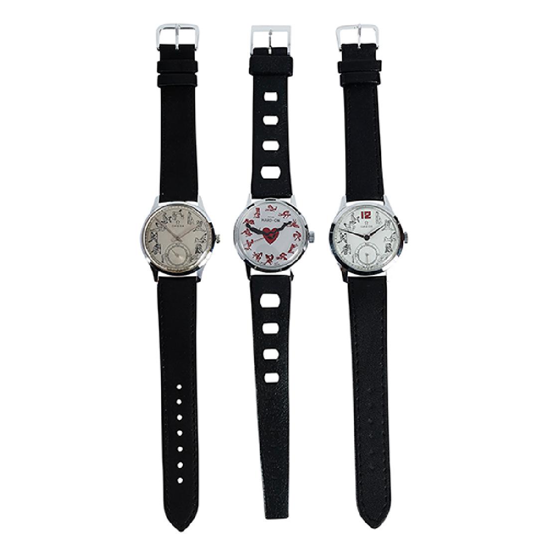 Omega, two (2) Sexual Positions wristwatches, stainless: Omega, two (2) Sexual Positions wristwatches, stainless steel cases, black leather bands, together with a “Hard-On" sexual positions wristwatch, 1 1/4"dia face