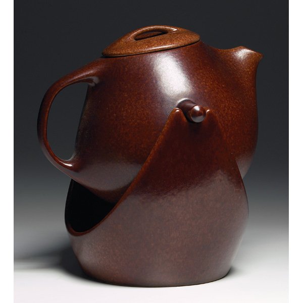 Roseville Raymor hanging teapot: Roseville Raymor hanging teapot, large shape covered in a mottled brown matt glaze, marked, 10"w x 12.5"h overall, repaired, minor chip to rim; with an Art Pottery creamer and sugar, (not shown), orga