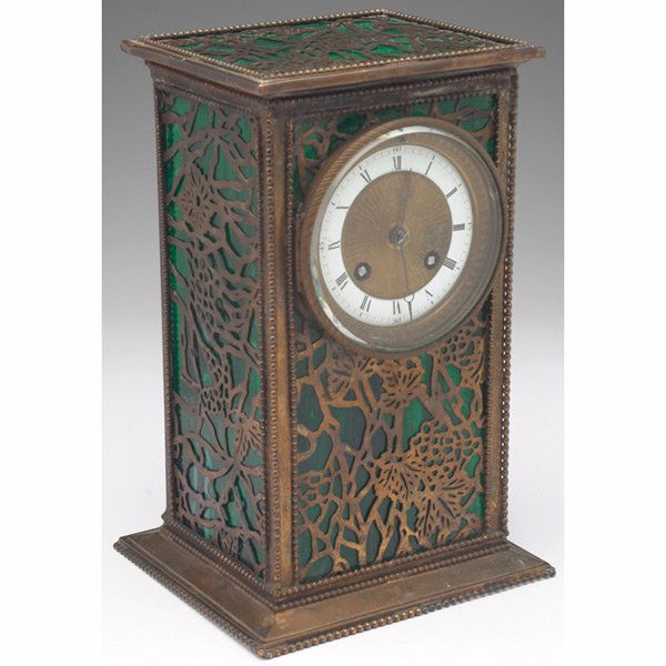 Riviere Studios clock: Riviere Studios clock, tall rectangular shape in bronze with a pierced organic design over green slag glass, marked, 7"w x 10.5"h