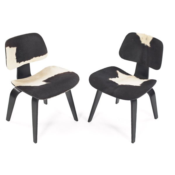 Eames DCWs, pair, Herman Miller, ash with cowhide: Charles and Ray Eames DCWs, pair, by Herman Miller, 1960s, ebonized ash plywood frames, both with added black and white cowhide upholstery, oval back shock mounts, 19.25w x 21d x 29h, very good condit