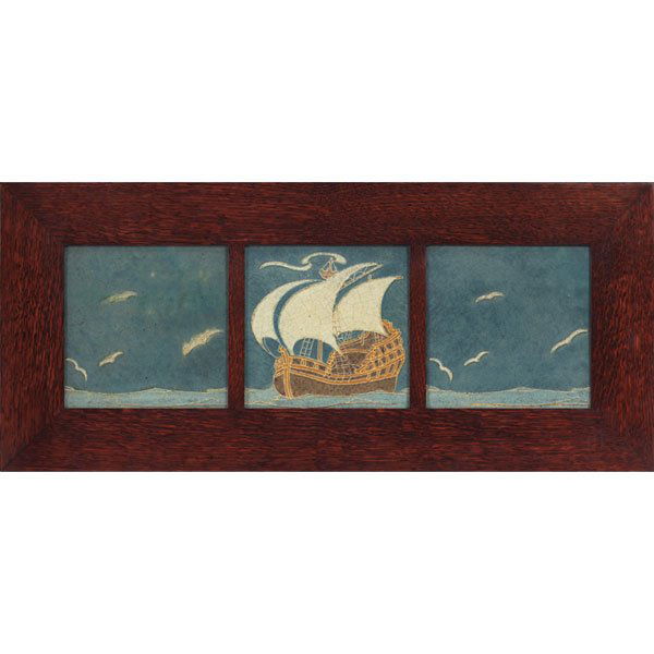 Grueby tile frieze, three tiles depicting: Unusual Grueby tile frieze, three tiles depicting a ship at sea among birds in flight, colorful matt glaze, painted initials on back, held in an Arts and Crafts oak frame, each tile: 8.5"sq, overall: