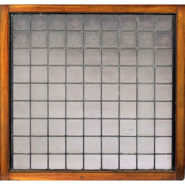 Luxfer prism window, leaded purple-tinted glass: Luxfer prism window, leaded purple-tinted glass prisms held in a wood frame, with twenty-four interior Frank Lloyd Wright designed prisms, one prism signed Luxfer Patented, overall: 42"w x 40"h, each