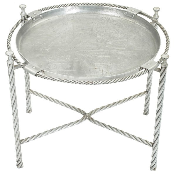 Wendell August tray and folding stand: Wendell August tray and folding stand, aluminum, 1937, hand hammered tray with decoration of a female figure and boats, stamped "Wendell August" and engraved " 1937 Inter-Lake Regatta Put-In Bay" and