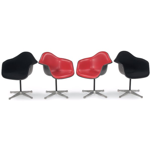 Charles and Ray Eames shell chairs 4 dark gray red: Charles and Ray Eames shell chairs, four, by Herman Miller, dark gray fiberglass shells, two with red-orange wool upholstery and two with black upholstery, four-point aluminum bases, swivel, 26"w x 24