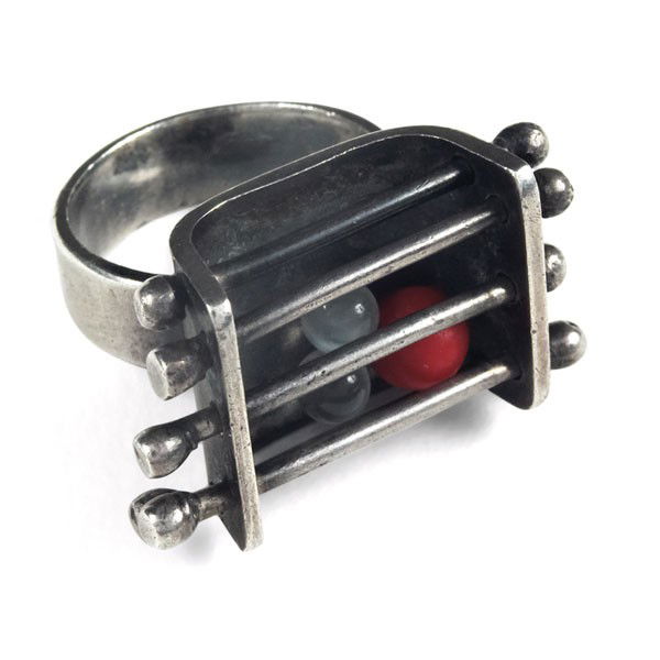 Ed Wiener kinetic ring, sterling: Ed Wiener kinetic ring, sterling, three loose beads move in a sterling rod cage, one bead is coral, stamped "STERLING ED WIENER", approximate size is 9, .75" x 1.25", very good original condition