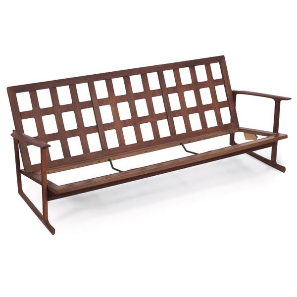 Ib Kofod-Larsen sofa, by Selig: Ib Kofod-Larsen sofa, by Selig, walnut, grid-work panel to back, original finish, signed with Selig decal and label, seat support straps missing, original orange wool cushions included but not shown,