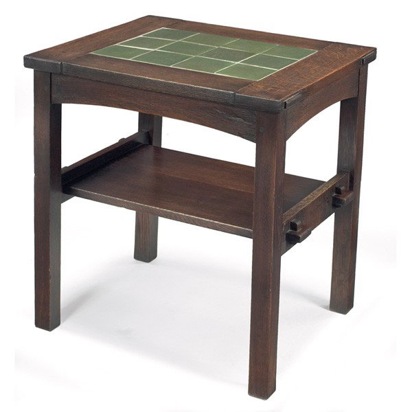 Gustav Stickley twelve tile tea table: Gustav Stickley twelve tile tea table, rectangular top with inset green Grueby tiles over an arched apron and lower shelf supported by double key and tenon construction, tiles have been re-grouted, re