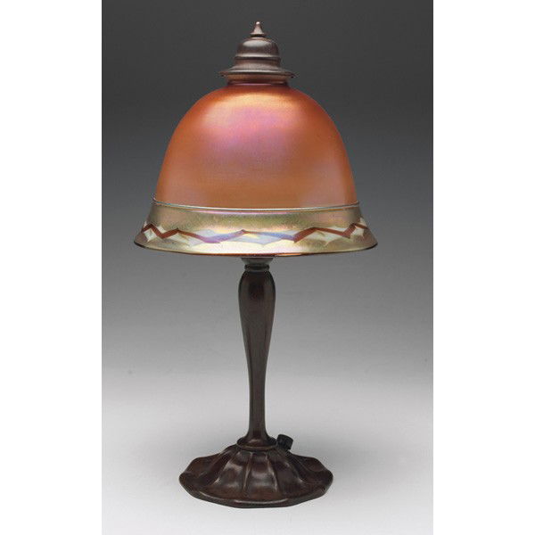 Tiffany Furnaces/Steuben lamp: Tiffany Furnaces/Steuben lamp, Tiffany bronze base, supporting a Steuben glass shade with a pulled design at edge, base signed Louis C. Tiffany Furnaces, Inc., Favrile, #16A, shade unsigned, overall: