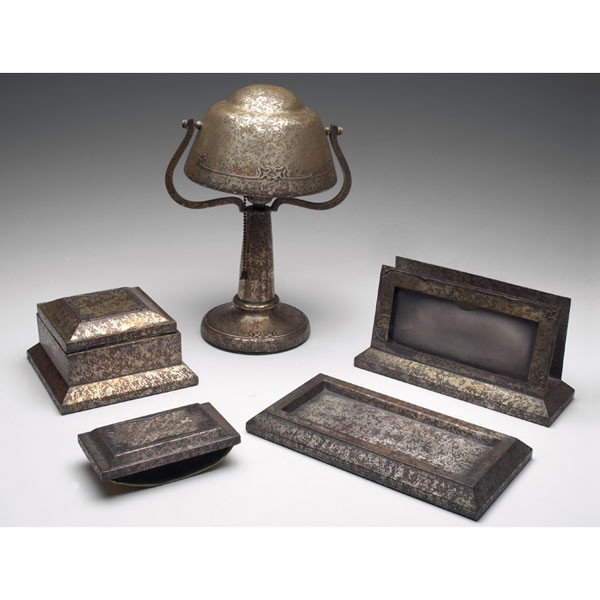 Heintz desk pieces, sterling on bronze: Heintz desk pieces, sterling on bronze, five, inkwell: 6"w x 3.5"h, rocker blotter: #104, 5.5"l, lamp: 9"w x 12.5"h, letter rack: 9"l x 5"h, tray: 5"w x 10"l, all in bronze with applied designs, #1206